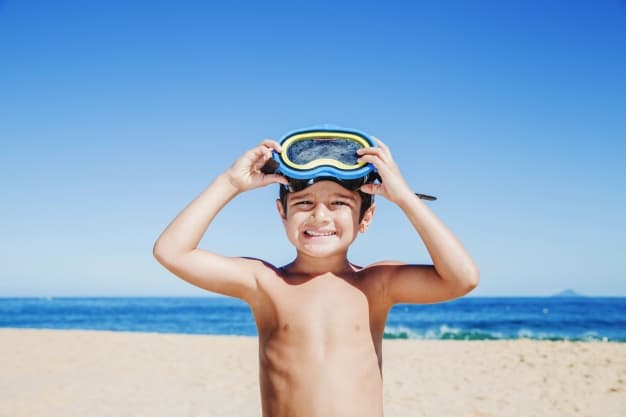 boy in a beach ready to swim