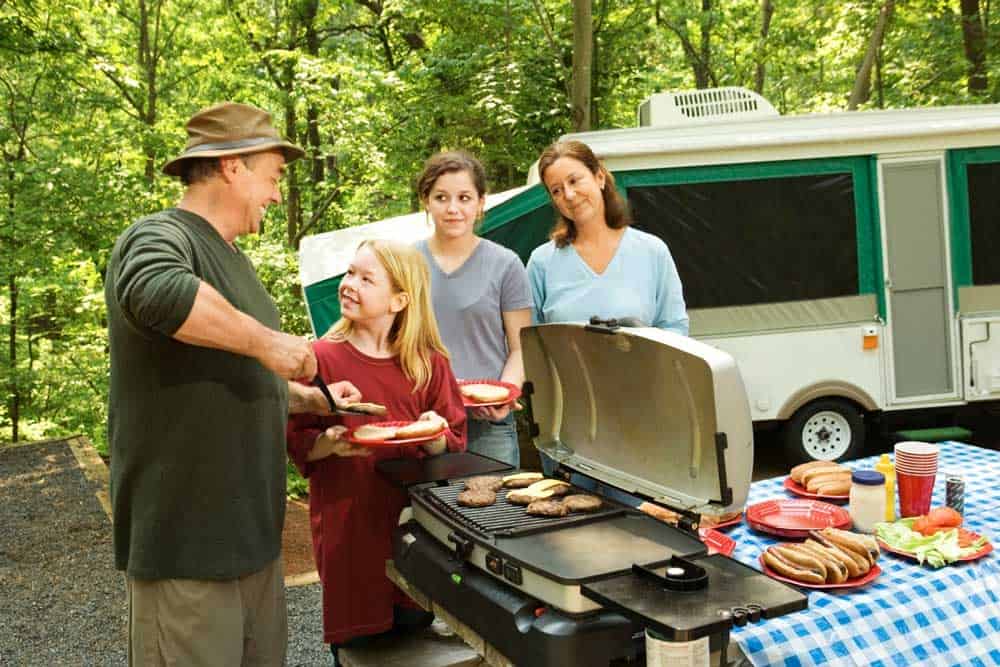 Family camping in the woods with electricity