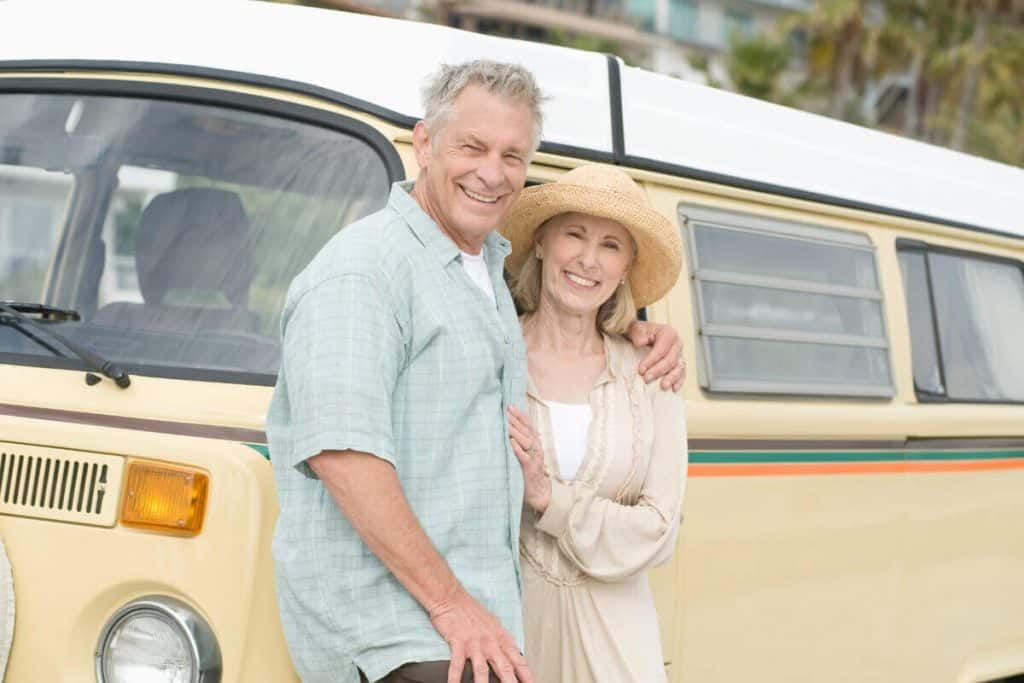 Man and woman posing with their campervan