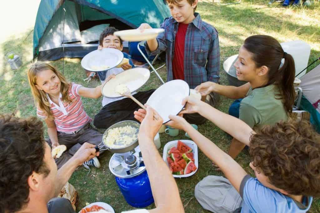 family eating in camp